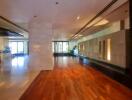 spacious modern lobby with wooden flooring and accent lighting