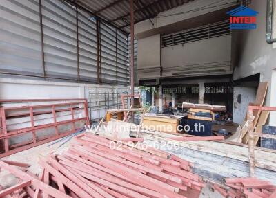 Construction site of a building with materials and tools scattered around.