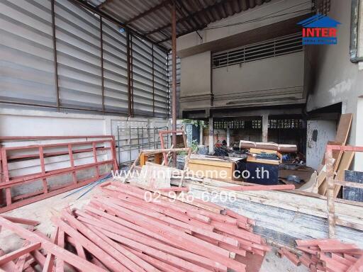 Construction site of a building with materials and tools scattered around.