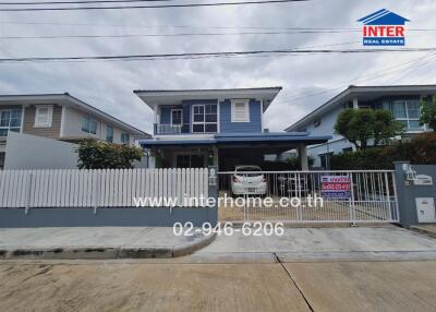 Two-story house with a front yard and driveway