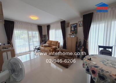 Spacious living room with large windows and natural light