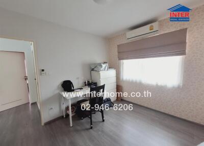 Modern bedroom with work desk and ample natural light