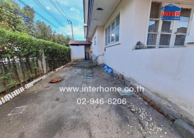 Exterior view of the property with driveway and garden area