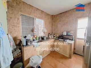 A well-used kitchen with various appliances and utensils