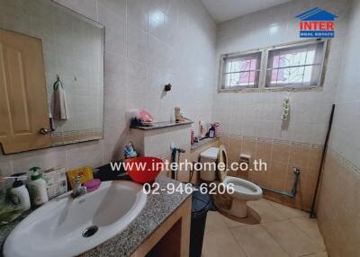 Bathroom with sink, mirror, and toilet