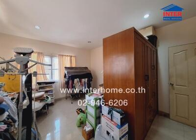 Bedroom with wardrobe and stacked boxes