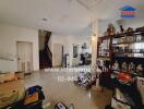 Living room with staircase and various storage items