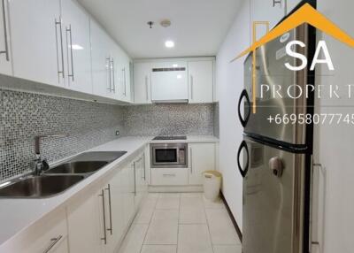 Modern kitchen with white cabinets and mosaic backsplash