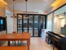 Dining area with wooden table and bench, adjacent glass door and piano