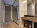 Hallway with built-in mirror wardrobe and vanity desk