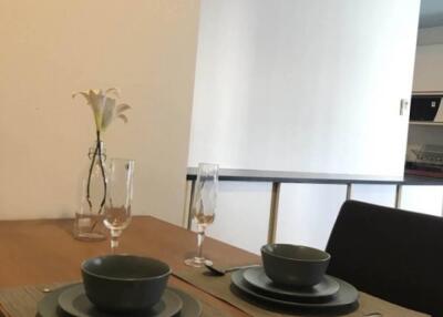 Dining area setup with tableware and flower vase