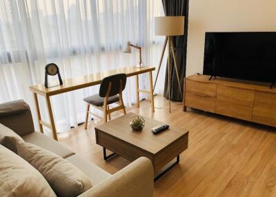 Modern living room with wooden furniture and a large TV