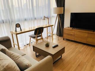 Modern living room with wooden furniture and a large TV