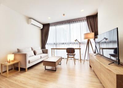 Modern living room with natural light and contemporary furnishings