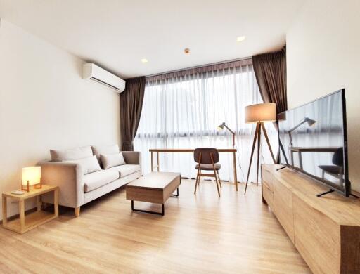 Modern living room with natural light and contemporary furnishings