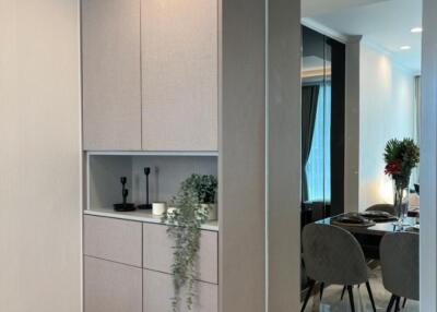 Stylish corridor view leading to dining area with modern cabinetry