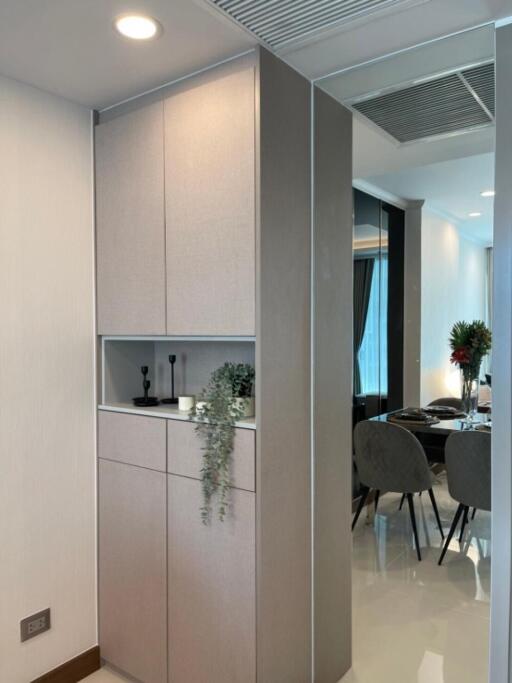 Stylish corridor view leading to dining area with modern cabinetry