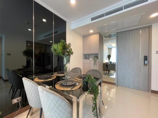 Modern dining area with glass table and gray upholstered chairs