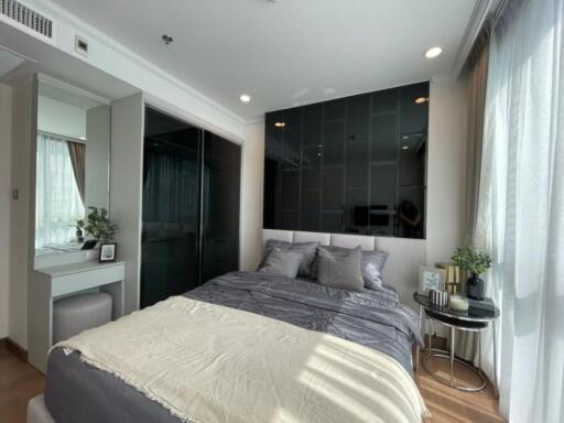 Modern bedroom with a large window and natural light