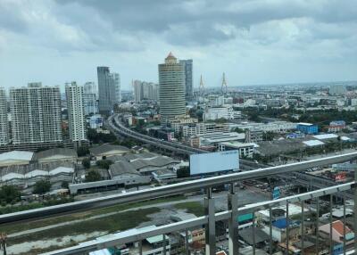 View from a high-rise balcony overlooking the cityscape