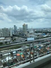 View from a high-rise balcony overlooking the cityscape