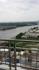 View from the balcony overlooking a river and cityscape