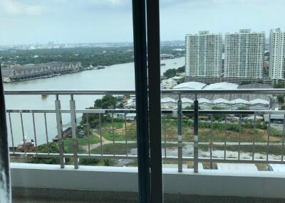 Balcony with a view of river and buildings