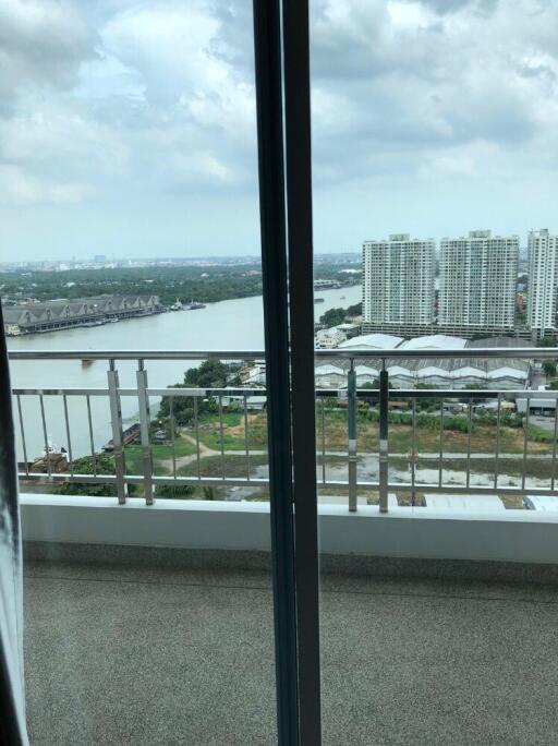 Balcony with a view of river and buildings