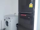 Utility room with washing machine and refrigerator