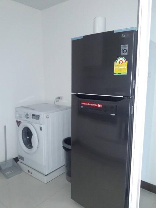 Utility room with washing machine and refrigerator