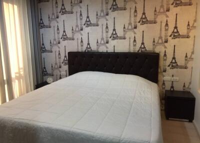 Bedroom with bed and Eiffel Tower-themed wallpaper