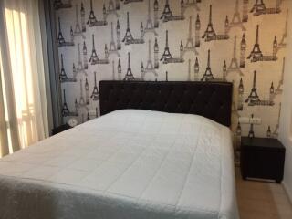 Bedroom with bed and Eiffel Tower-themed wallpaper