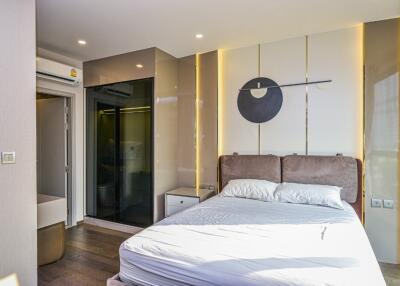 Modern bedroom with artistic decor and ensuite bathroom