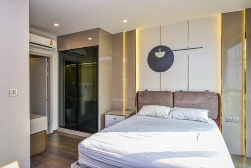 Modern bedroom with artistic decor and ensuite bathroom