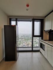 Modern kitchen area with city view and appliances