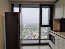 Modern kitchen area with city view and appliances