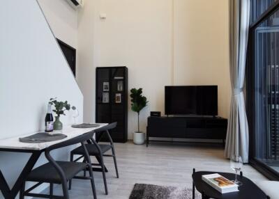 Modern high-ceiling living room with dining area