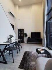 Modern high-ceiling living room with dining area