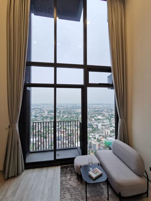 Living room with large windows and city view