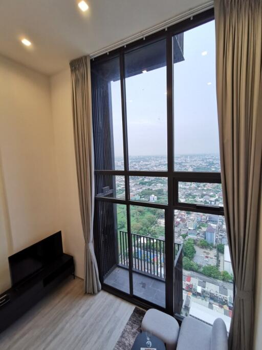 Modern living room with large window and city view