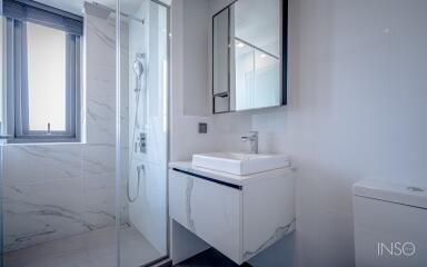 Modern bathroom with shower, sink, and toilet