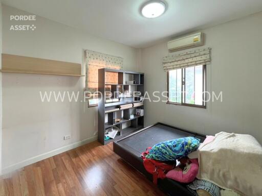 Small bedroom with wooden floor and window