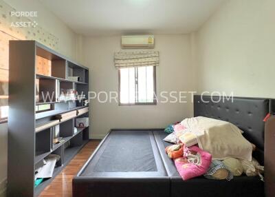 Bedroom with shelving and bed