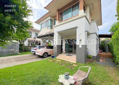 Modern two-storey house with driveway and garden