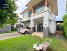 Modern two-storey house with driveway and garden