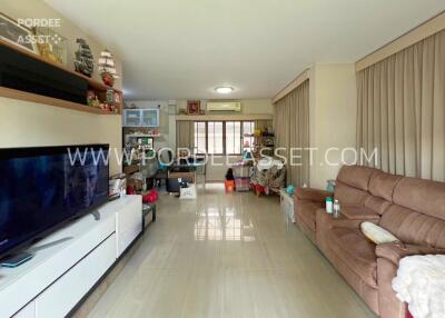 Spacious living room with large windows and ample seating