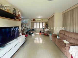 Spacious living room with large windows and ample seating