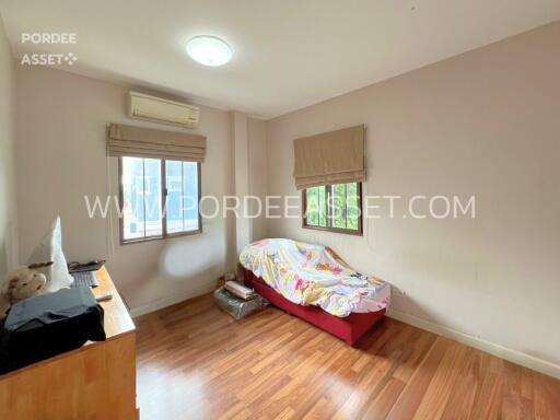 A cozy bedroom with wooden flooring and a small bed