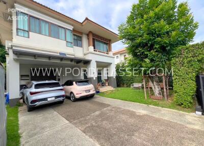 Front view of a residential house with driveway and parking area