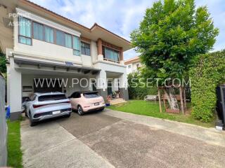 Front view of a residential house with driveway and parking area